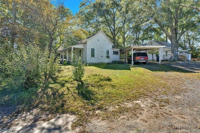 exterior space featuring a carport and a front yard