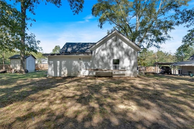 back of house with a lawn and a shed