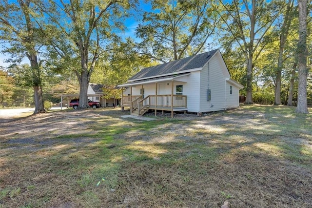 exterior space with a carport, a front yard, and a deck