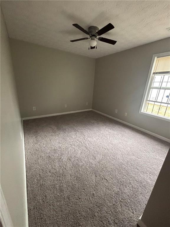 rear view of property featuring central AC unit and a yard