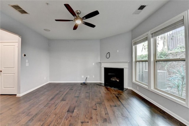 3351 Vintage Cir SE, Smyrna, GA 30080 - unfurnished living room with ceiling fan, dark wood finished floors, a fireplace with raised hearth, and baseboards