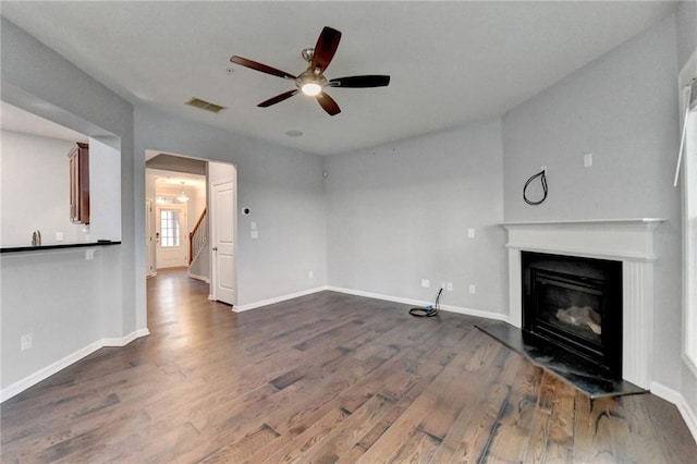 3351 Vintage Cir SE, Smyrna, GA 30080 - unfurnished living room featuring a glass covered fireplace, dark wood finished floors, stairway, and baseboards