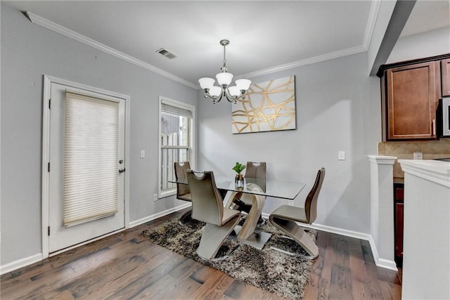 3351 Vintage Cir SE, Smyrna, GA 30080 - dining space featuring a chandelier, ornamental molding, dark wood-type flooring, and baseboards