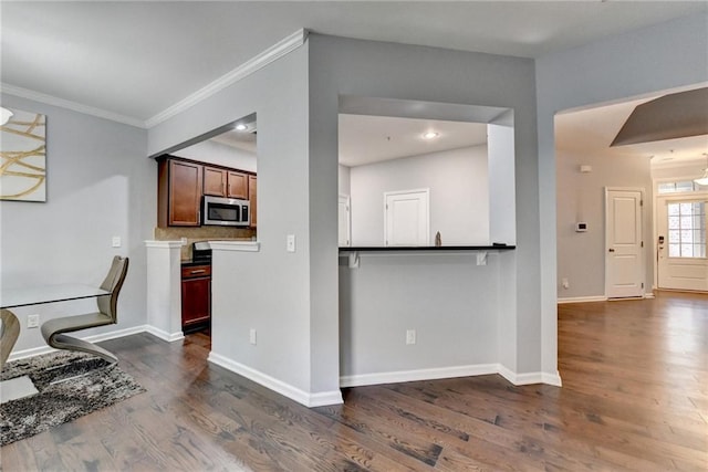 3351 Vintage Cir SE, Smyrna, GA 30080 - kitchen featuring stainless steel microwave, dark wood finished floors, ornamental molding, and baseboards