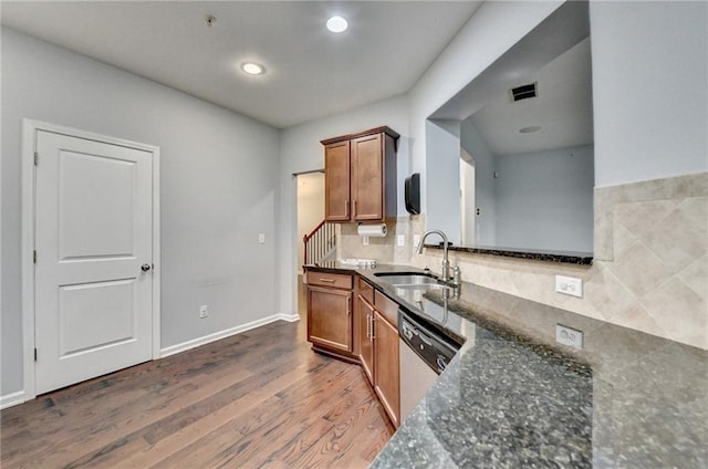 3351 Vintage Cir SE, Smyrna, GA 30080 - kitchen with a sink, stainless steel dishwasher, brown cabinets, dark wood finished floors, and dark stone counters