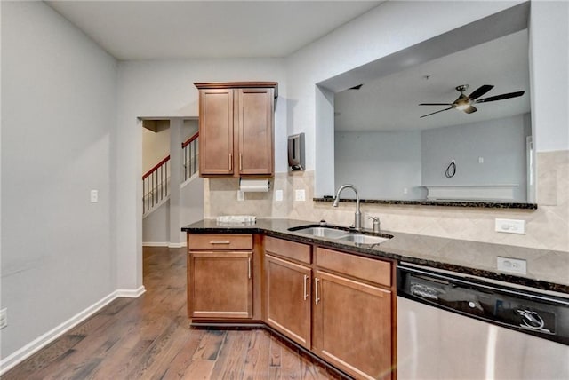 3351 Vintage Cir SE, Smyrna, GA 30080 - kitchen featuring a sink, dishwasher, a ceiling fan, decorative backsplash, and dark stone counters