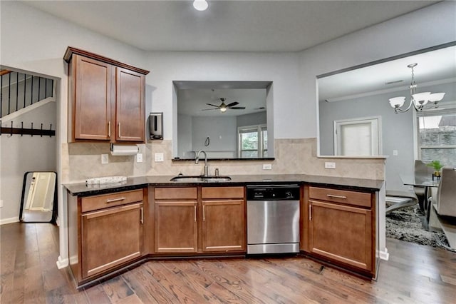 3351 Vintage Cir SE, Smyrna, GA 30080 - kitchen with dishwasher, a sink, a chandelier, dark wood-style floors, and decorative backsplash