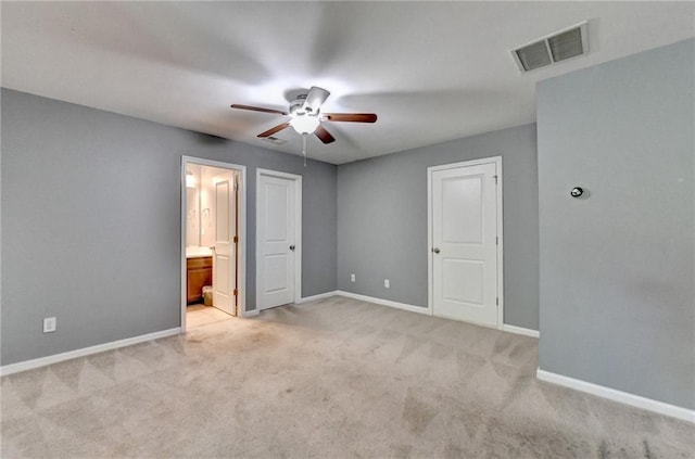 3351 Vintage Cir SE, Smyrna, GA 30080 - unfurnished bedroom featuring light carpet, baseboards, connected bathroom, and a ceiling fan