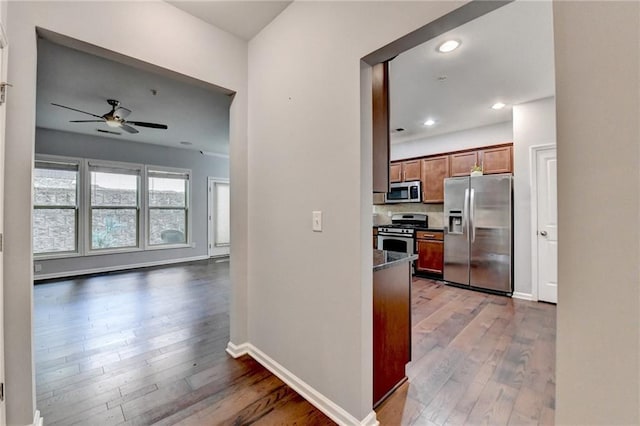 3351 Vintage Cir SE, Smyrna, GA 30080 - kitchen featuring stainless steel appliances, a ceiling fan, wood-type flooring, brown cabinetry, and recessed lighting