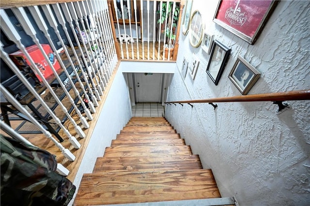 staircase with a textured wall