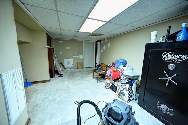 finished basement featuring visible vents and a drop ceiling