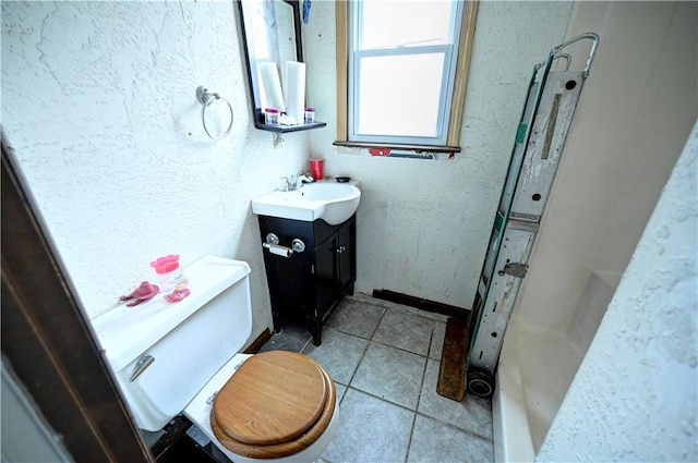 bathroom with tile patterned flooring, toilet, vanity, and a shower