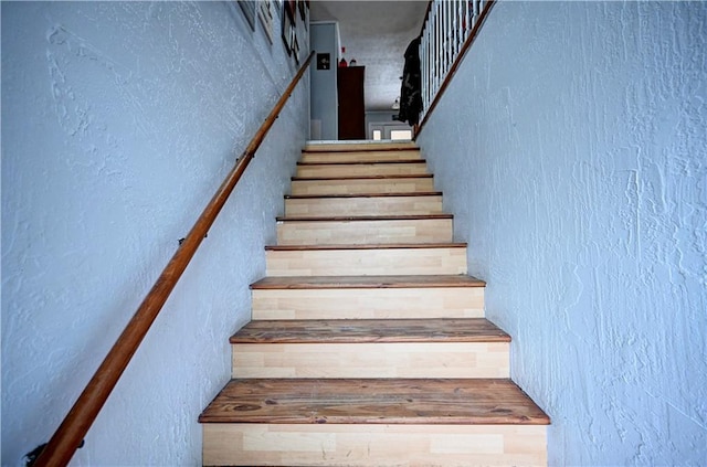 stairway with a textured wall