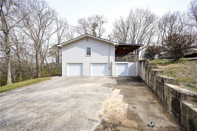 view of home's exterior with driveway and a garage