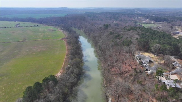 birds eye view of property featuring a rural view, a forest view, and a water view