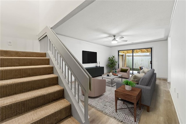 living room featuring light wood-type flooring and ceiling fan