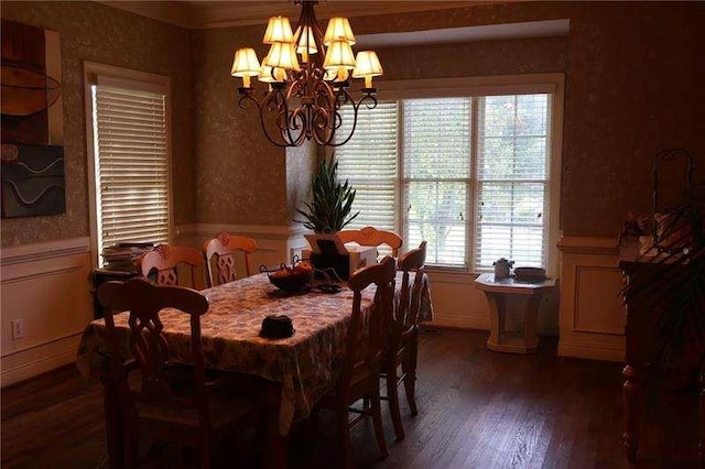 dining room featuring wood finished floors, a notable chandelier, and a wainscoted wall