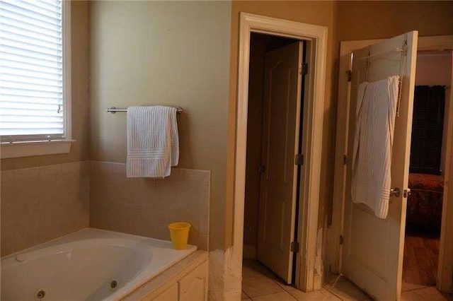 full bathroom featuring tile patterned flooring and a tub with jets