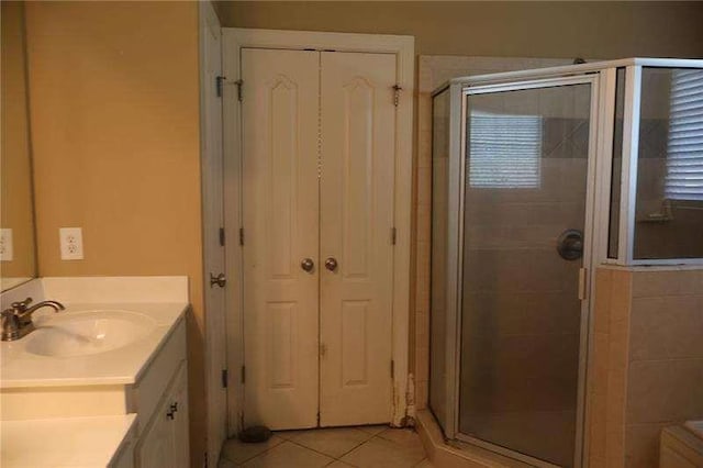 full bath with tile patterned flooring, vanity, and a shower stall