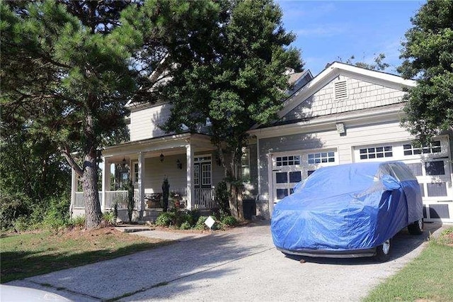 view of front facade featuring a porch and a garage