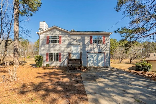 view of front of house with a garage, driveway, and a chimney