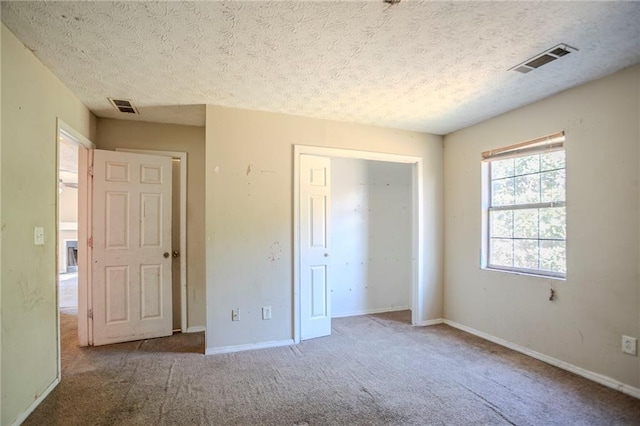 unfurnished bedroom featuring carpet floors, a closet, visible vents, and baseboards