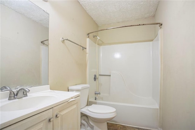 bathroom with toilet, bathtub / shower combination, a textured ceiling, and vanity