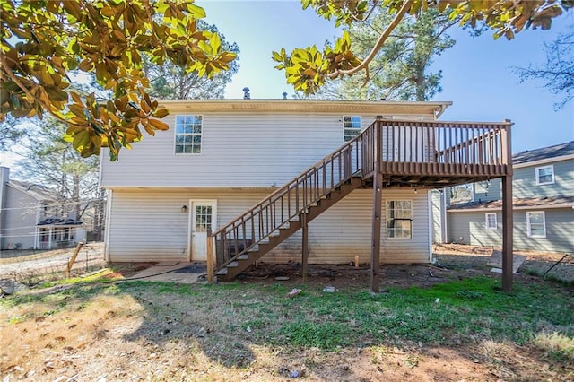 rear view of house featuring stairway and a wooden deck