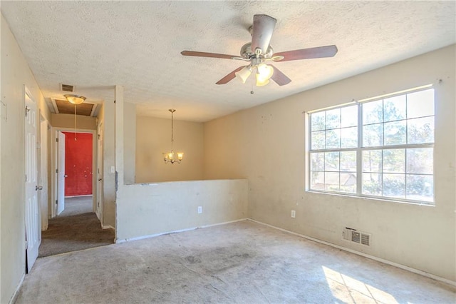 unfurnished room with attic access, visible vents, and a textured ceiling