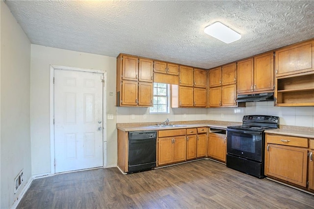 kitchen with black appliances, brown cabinets, a sink, and under cabinet range hood