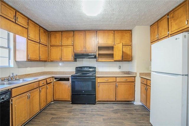 kitchen featuring dark wood-style floors, brown cabinets, a sink, under cabinet range hood, and black appliances