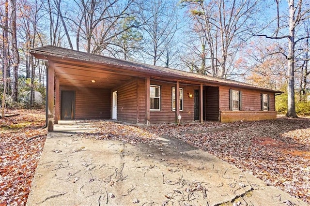 ranch-style house featuring a carport