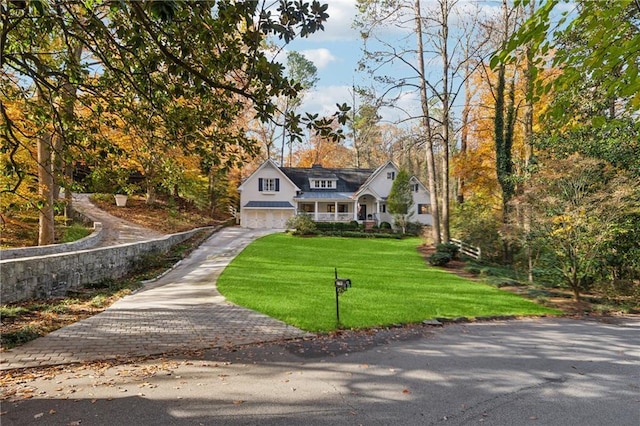 view of front of house with a garage and a front lawn