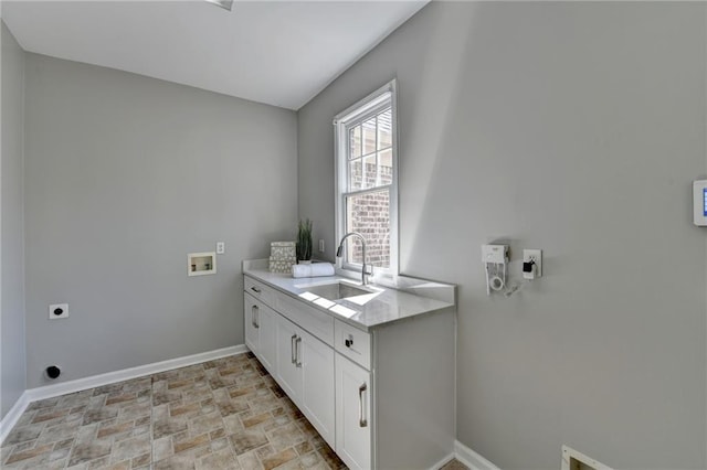 laundry area with washer hookup, cabinet space, hookup for an electric dryer, a sink, and baseboards