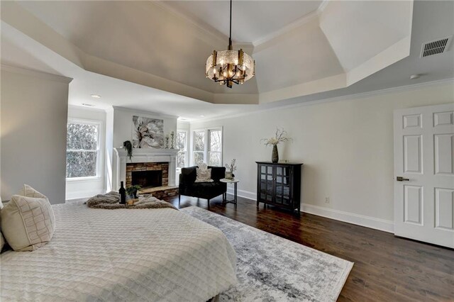 bedroom with visible vents, multiple windows, a tray ceiling, and crown molding