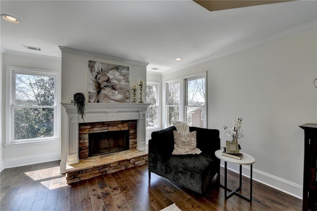 sitting room with ornamental molding, wood finished floors, and visible vents