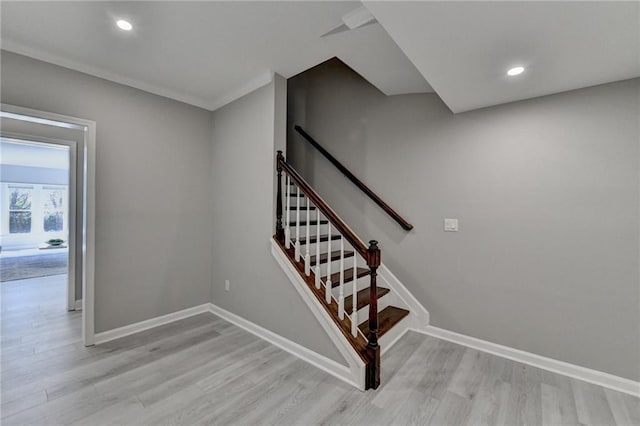 stairway featuring recessed lighting, baseboards, and wood finished floors