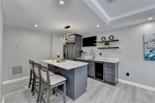 bar featuring light wood finished floors, visible vents, wine cooler, stainless steel refrigerator with ice dispenser, and a sink