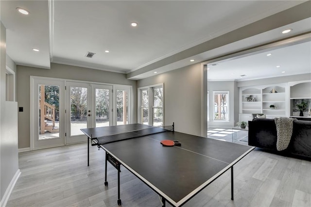 game room with light wood-style floors, recessed lighting, french doors, and crown molding