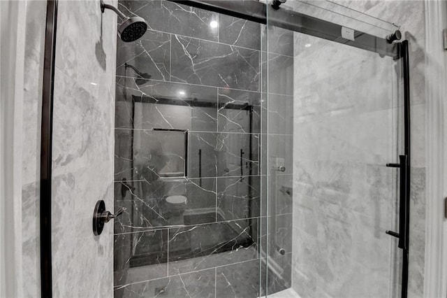 bathroom with a marble finish shower