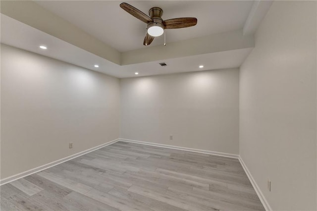 spare room with recessed lighting, visible vents, light wood-style flooring, and baseboards