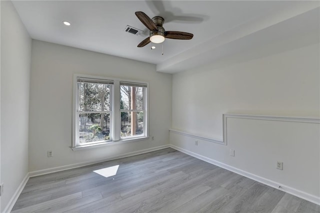 empty room featuring recessed lighting, wood finished floors, visible vents, and baseboards