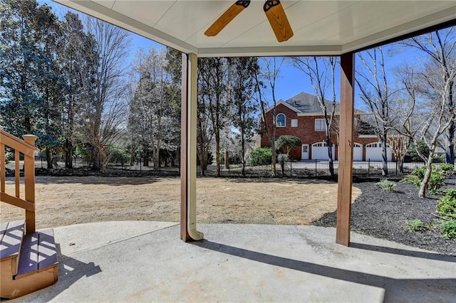 view of yard featuring a patio, fence, and a ceiling fan