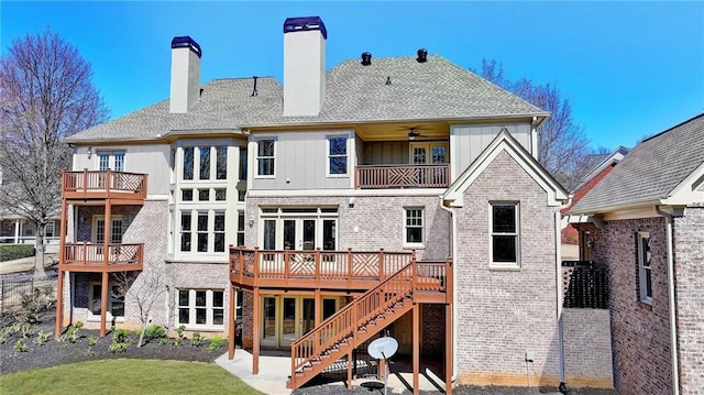 rear view of property featuring a patio, brick siding, board and batten siding, and french doors