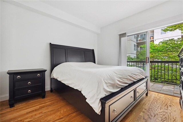 bedroom featuring access to outside and light wood finished floors