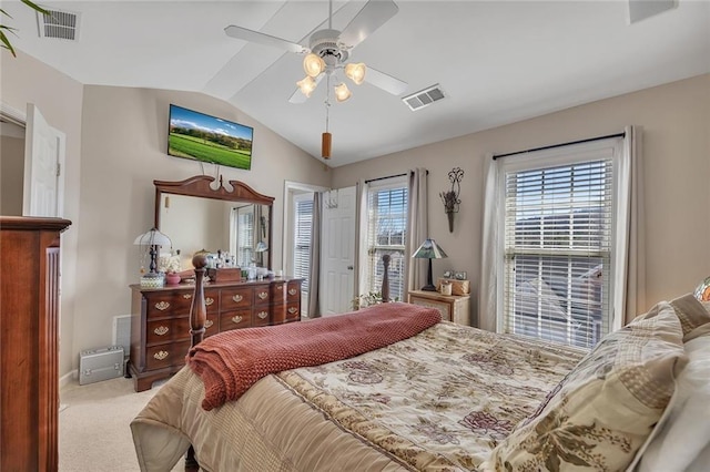 bedroom with lofted ceiling, carpet flooring, visible vents, and a ceiling fan