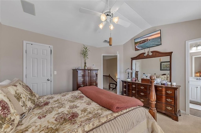 bedroom featuring ensuite bathroom, carpet floors, visible vents, a ceiling fan, and vaulted ceiling