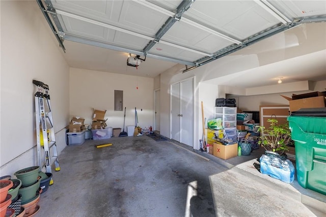 garage with electric panel and a garage door opener