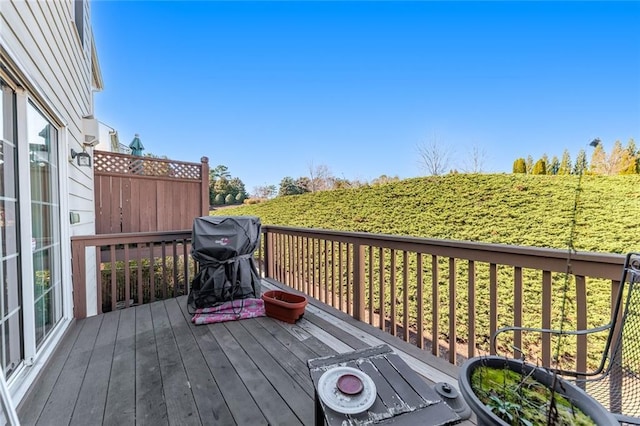 wooden terrace featuring a grill