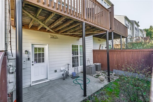 view of patio / terrace with central air condition unit and fence